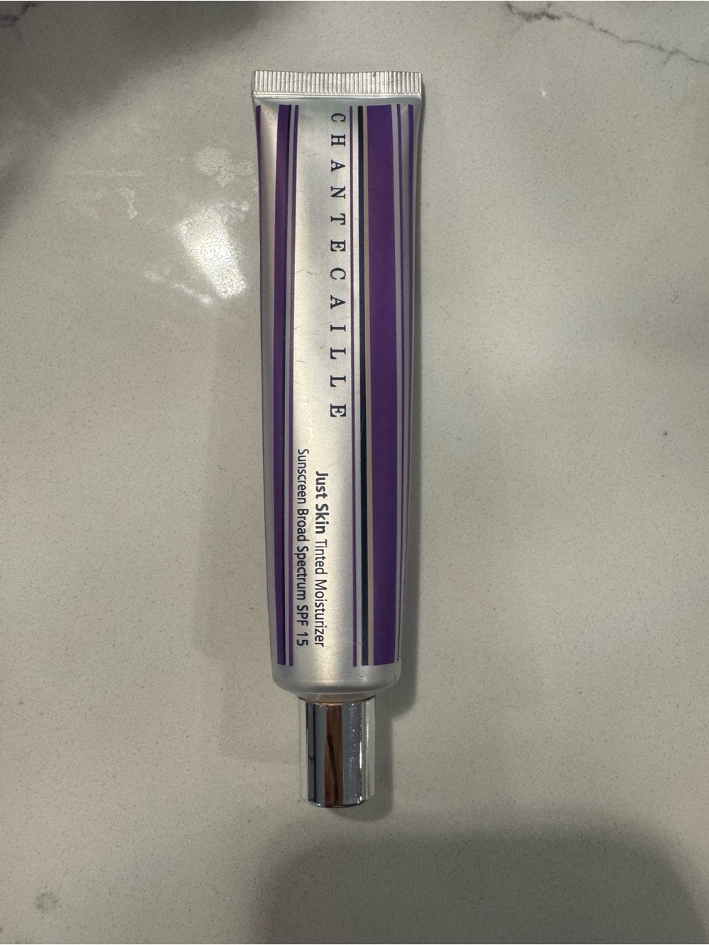 Chantecaille Just Skin Tinted Moisturizer Bliss Silver Tube with Purple Accents